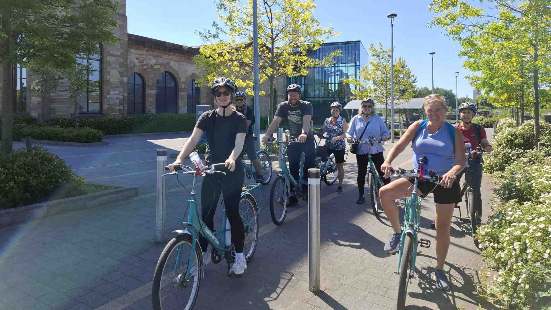 Group of friends cycling at the Clydeside Distillery Glasgow in the sunshine
