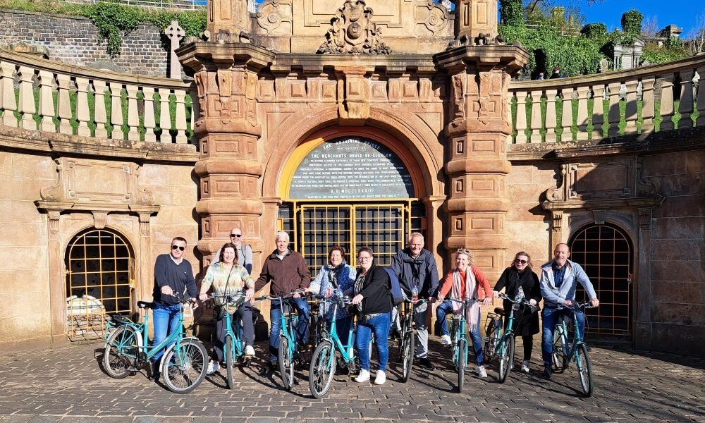 people on bikes at the Necropolis Glasgow on tour on a sunny day